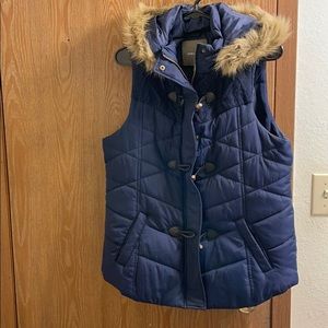 Maurice’s navy blue vest with detachable hood